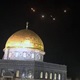 The Dome of the Rock atop the Temple Mount in Jerusalem's Old City, with the lights of missile interceptions